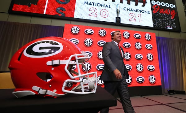 Georgia head coach Kirby Smart takes the stage for his press conference at SEC Media Days with 2021 National Champions flashing on the screen in the College Football Hall of Fame on Wednesday, July 20, 2022, in Atlanta.   (Curtis Compton / Curtis Compton@ajc.com)