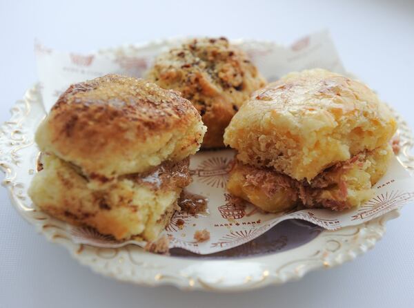 A cinnamon filled biscuit, a country ham biscuit with chopped Edwards Virginia Ham, and a black pepper bacon biscuit. (BECKYSTEIN.COM)