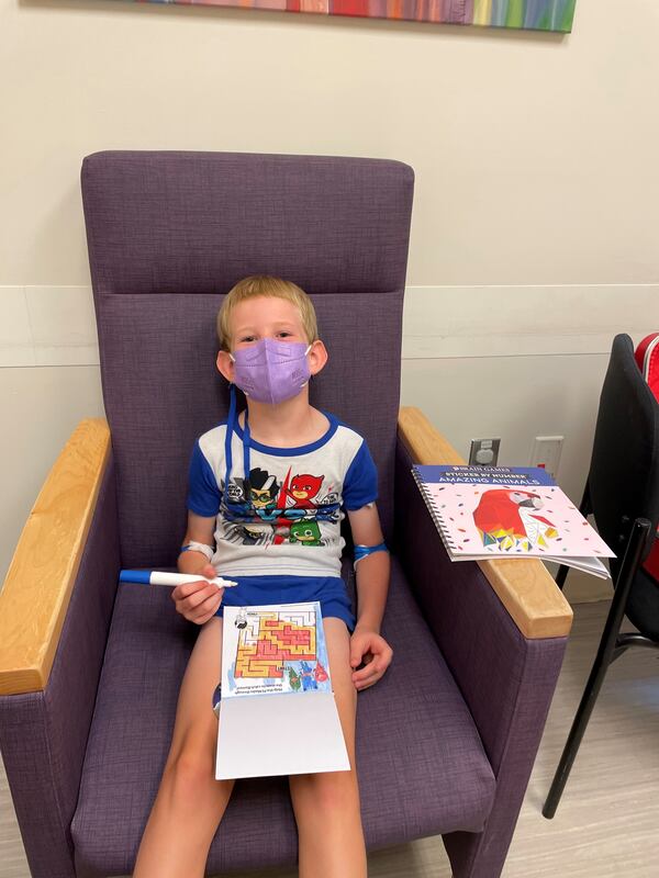 Willy Randall, 6, is shown here after getting his shot in the Moderna COVID-19 vaccine trial.  His mother, Dr. Lori Randall, is an internal medicine doctor and doesn't know whether he got the vaccine or a placebo.  But she has high hopes he got the vaccine. (Photo courtesy of Lori Randall)