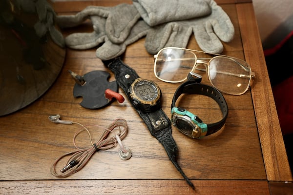 The eyeglasses and watches Leonard Peltier brought home from prison sit on his nightstand in Belcourt, N.D, on Tuesday, Feb. 25, 2025. (AP Photo/Mark Vancleave)