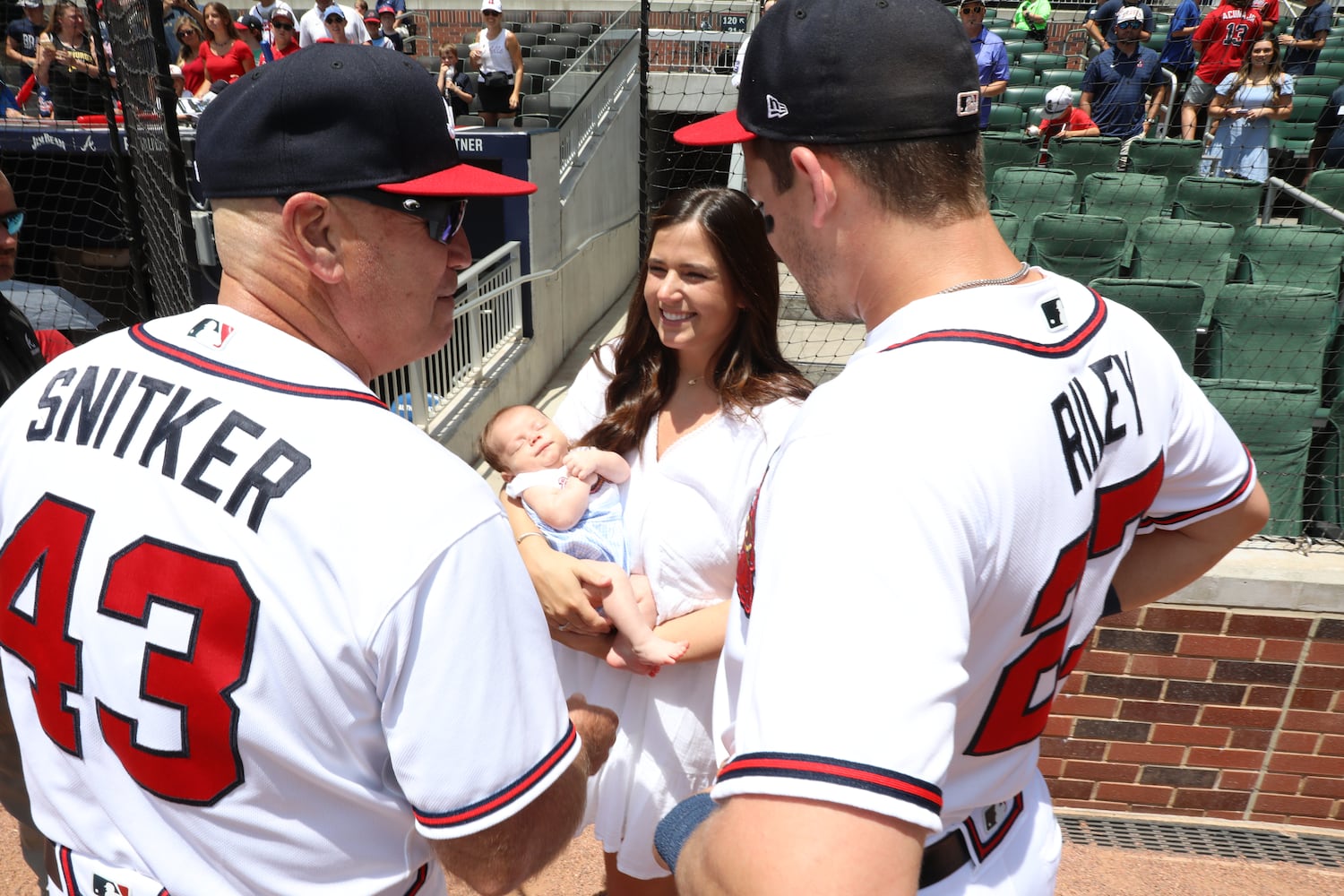 Braves third baseman Austin Riley and wife Anna introduce their son to Braves manager Brian Snitker before the game against the Pittsburgh Pirates on Sunday, June 12, 2022, in Atlanta. (Miguel Martinez / miguel.martinezjimenez@ajc.com) 