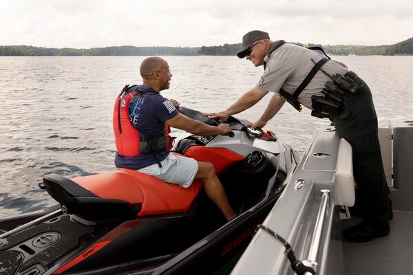 DNR Game Warden Jason Roberson, right, conducts a safety check with Sea-Doo watercraft owner Robert Richard on Lake Lanier Thursday, June 30, 2022, in Flowery Branch, Georgia. DNR prepares for a busy Holliday weekend on Lake Lanier. (Jason Getz / Jason.Getz@ajc.com)