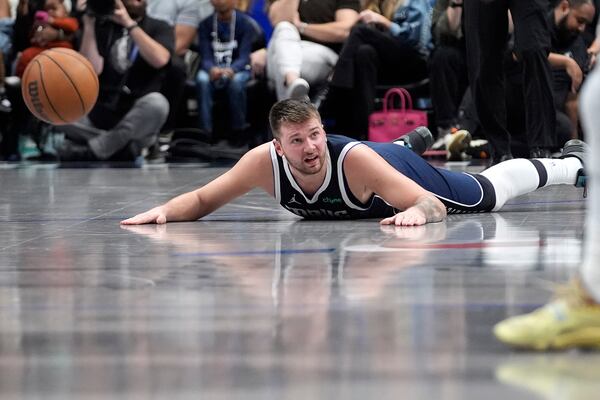 Dallas Mavericks guard Luka Doncic looks for the foul to be called after he fell during the second half of an NBA basketball game against the Phoenix Suns Friday, Nov. 8, 2024, in Dallas. (AP Photo/LM Otero)