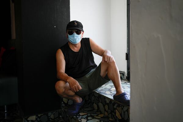 Wang Qiu, a migrant from China, poses for a portrait in Panama City, Tuesday, March 11, 2025, after being deported from the United States, detained for weeks in a Panamanian immigration camp, and released on a temporary humanitarian visa allowing a 30‑day stay. (AP Photo/Matias Delacroix)