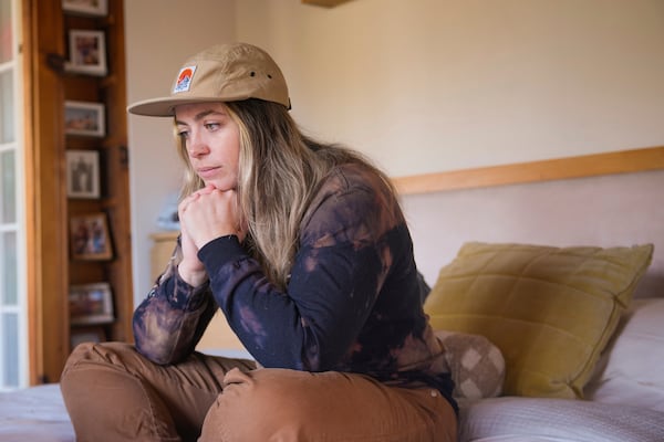 Displaced tenant Heather McAlpine, who lost her Altadena studio in the Eaton fire, pauses after searching online for a new rental home while living temporarily in Los Angeles on Monday, Feb. 17, 2025. (AP Photo/Damian Dovarganes)