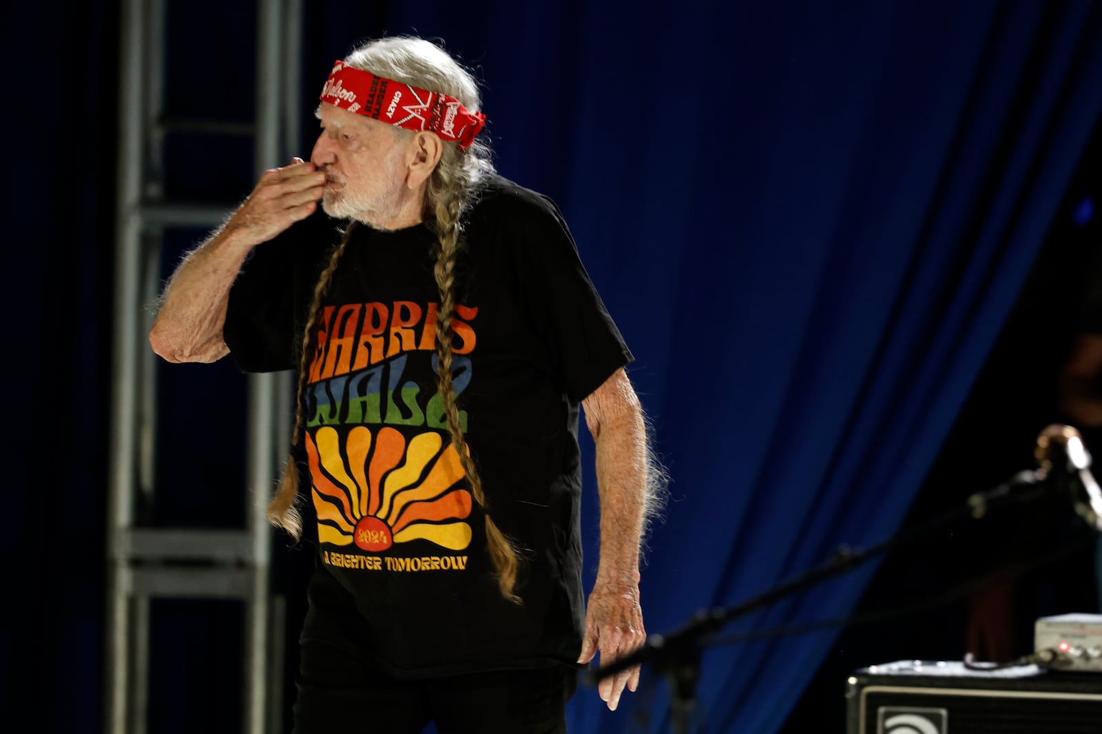 Willie Nelson blows a kiss to the crowd during a campaign rally for Democratic presidential nominee Vice President Kamala Harris, Friday, Oct. 25, 2024, in Houston. (AP Photo/Annie Mulligan)