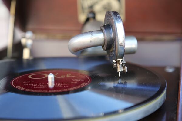 Preservationist Kyle Kessler plays the Morehouse College Quartet’s “Down by the Riverside” out of a hand-cranked Victrola Talking Machine in front of the historic building. The song was recorded in the building more than 95 years ago. (Tyson Horne / Tyson.Horne@ajc.com)