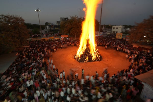 People perform rituals around the bonfire or sacred fire called 'Holi ka dahan' during Holi festival celebrations at Palaj village near Gandhinagar, India, Thursday, March 13, 2025. (AP Photo/Ajit Solanki)