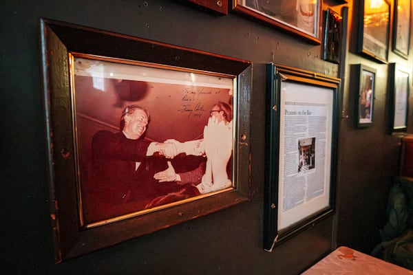 Photos and other memorabilia of former President Jimmy Carter adorn the walls of the Pinkie Masters bar in Savannah, GA on December 23, 2024. (Justin Taylor/The Atlanta Journal-Constitution)