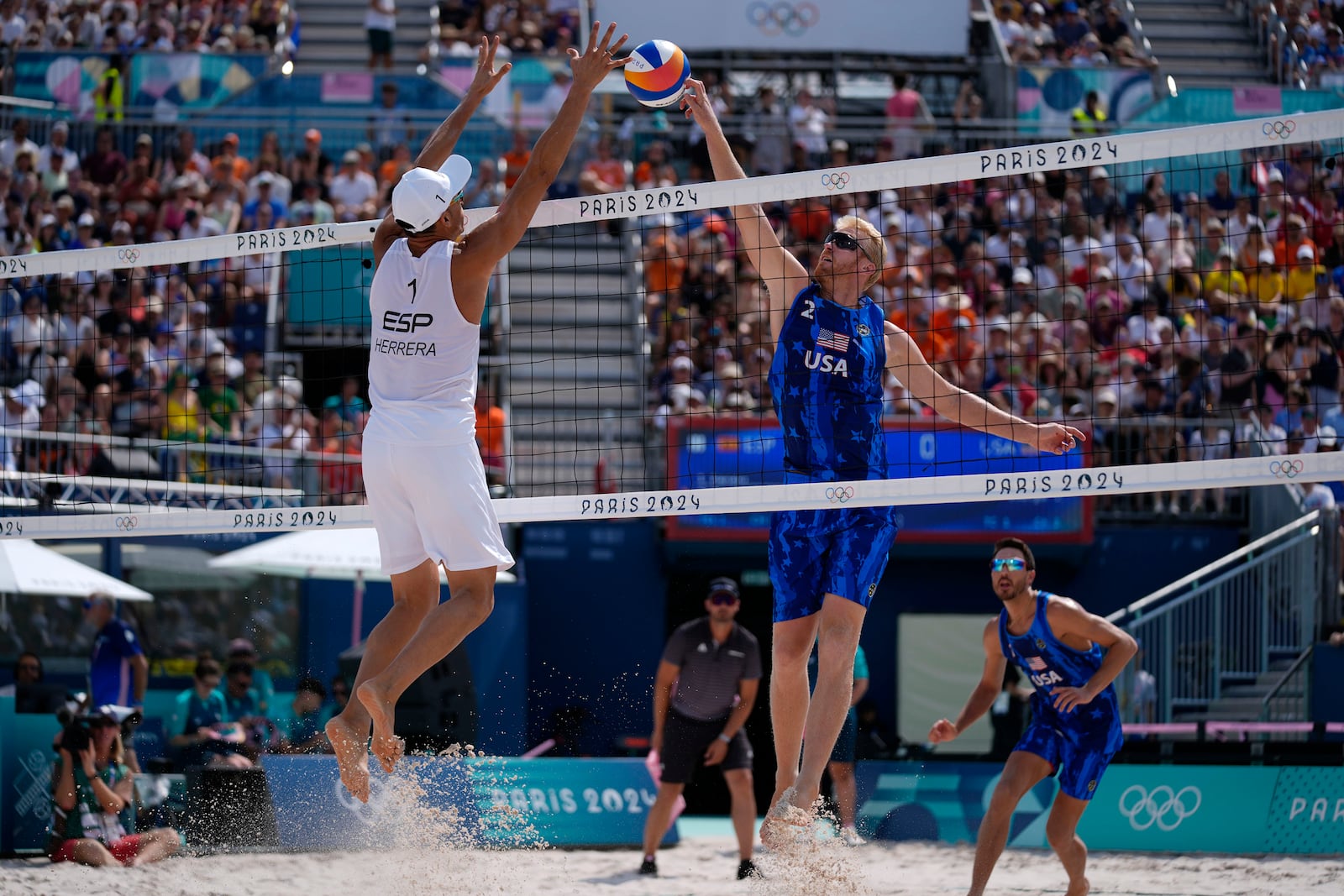 FILE - United States' Chase Budinger, center right, shoots against Spain's Pablo Herrera Allepuz, left, in a beach volleyball match at the 2024 Summer Olympics, Aug. 2, 2024, in Paris, France. (AP Photo/Robert F. Bukaty, File)