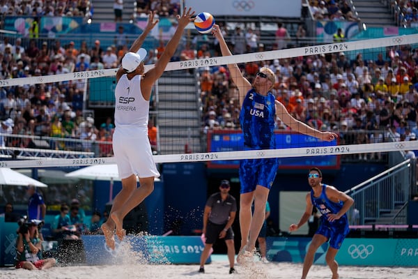 FILE - United States' Chase Budinger, center right, shoots against Spain's Pablo Herrera Allepuz, left, in a beach volleyball match at the 2024 Summer Olympics, Aug. 2, 2024, in Paris, France. (AP Photo/Robert F. Bukaty, File)