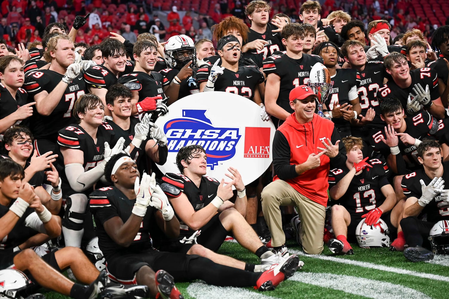 North Oconee head coach Tyler Aurandt and his team  celebrate their win over Marist in a Class 4A championship game at the Mercedes-Benz Stadium Monday, Dec. 16, 2024. (Photo/Daniel Varnado)