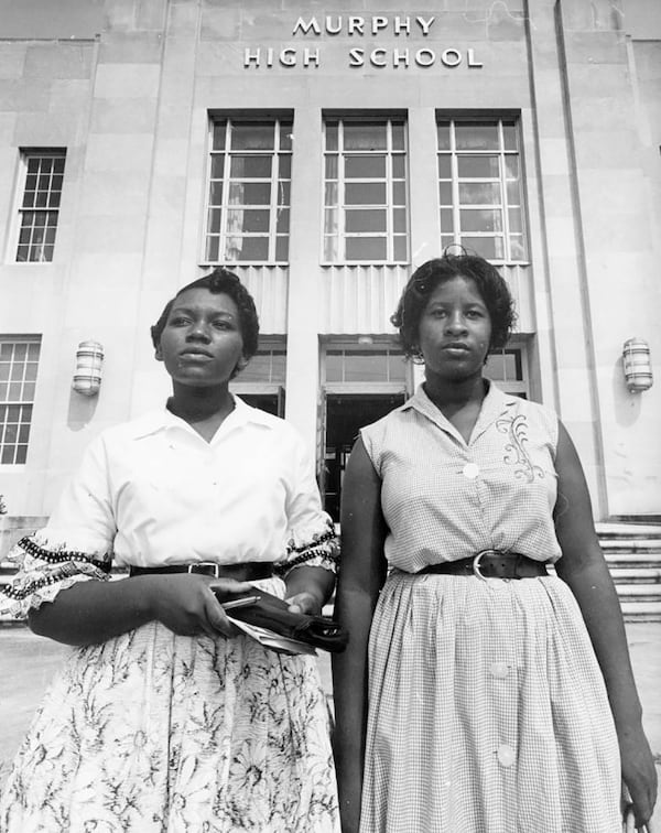 Students Martha Ann Holmes and Rosalyn Walton arrive at Murphy High School on Aug. 30, 1961. Holmes went on to graduate from Spelman and became an APS elementary school teacher. Walton became a system manager for the Internal Revenue Service. Walton (now Rosalyn Walton-Lees) was one of three Atlanta Nine students honored by the APS in a 2011 ceremony. (Bill Wilson / AJC Archive at the GSU Library AJCP297-004g)