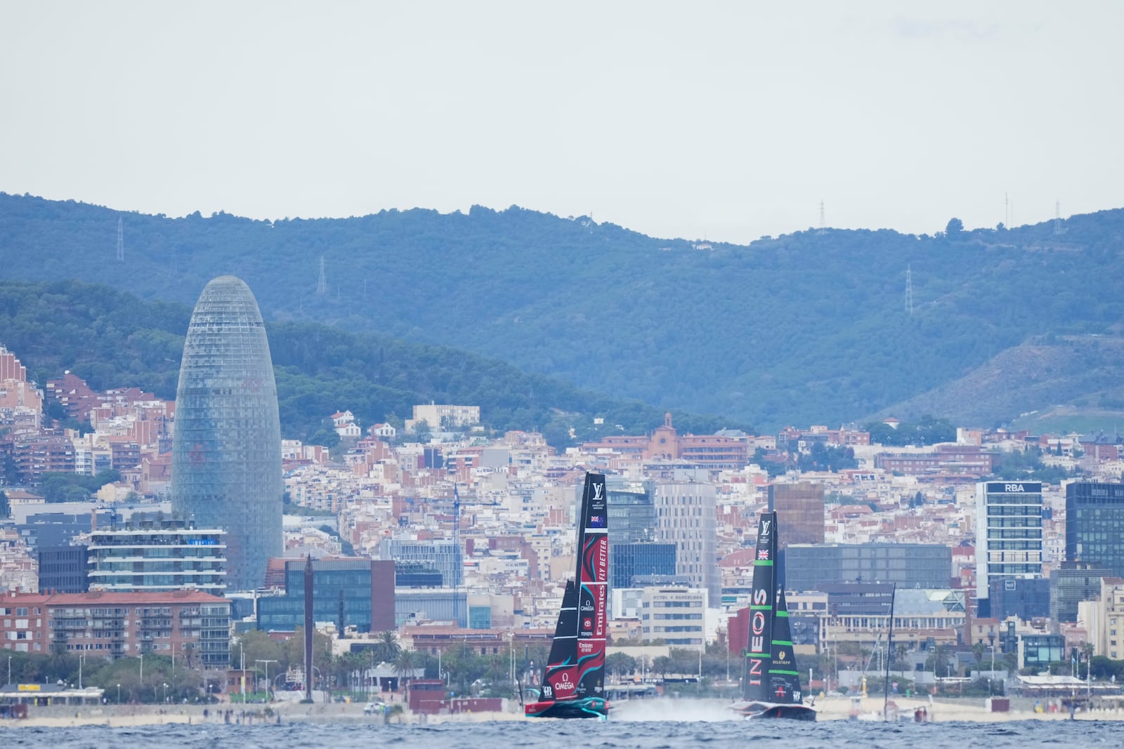 Ineos Britannia and Emirates Team New Zealand race during Louis Vuitton 37th America's Cup Day 5 race 8 in Barcelona, Spain, Friday, Oct. 18, 2024. (AP Photo/Bernat Armangue)