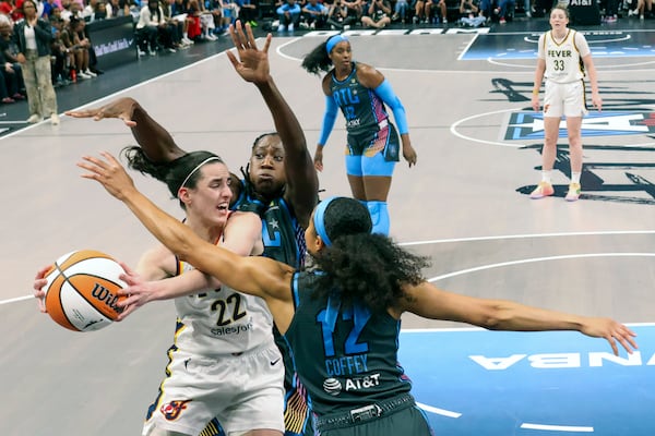 Indiana Fever guard Caitlin Clark (22) drives against Atlanta Dream center Tina Charles, facing, and Atlanta Dream forward Nia Coffey (12) during the first half at State Farm Arena, Friday, June 21, 2024, in Atlanta. Indiana won 91-79. (Jason Getz / AJC)
