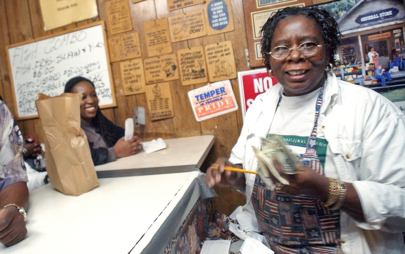 Frankie Rich, right, takes orders from customers at Bankhead Fish and Soul -- also known as Bankhead Seafood -- in 2006. / AJC file photo