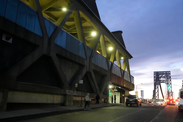 Traffic rolls past the George Washington Bridge Bus Station in New York, Friday, Dec. 6, 2024, near where the gunman fleeing Wednesday's shooting of UnitedHealthcare CEO Brian Thompson took a taxi to, according to surveillance video. (AP Photo/Richard Drew)