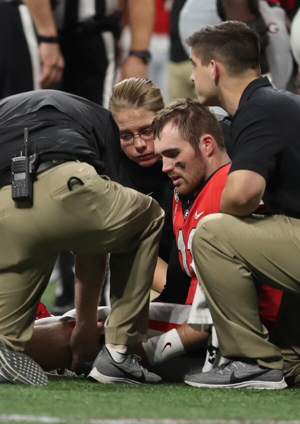 Georgia Bulldogs quarterback Jake Fromm (11) is injured during the first half of the Georgia vs. LSU SEC Football Championship game at Mercedes-Benz Stadium in Atlanta.  Alyssa Pointer / alyssa.pointer@ajc.com