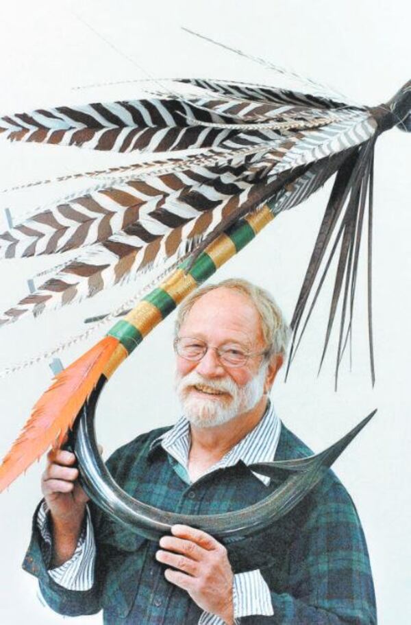 In a 2009 photo, Lincoln Stone holds one of his trout fly sculptures in his studio. He said at the time, "I don't like people walking by my stuff. I'm not going to bother doing it if nobody's going to look at it."  (Andy Sharp / AJC)