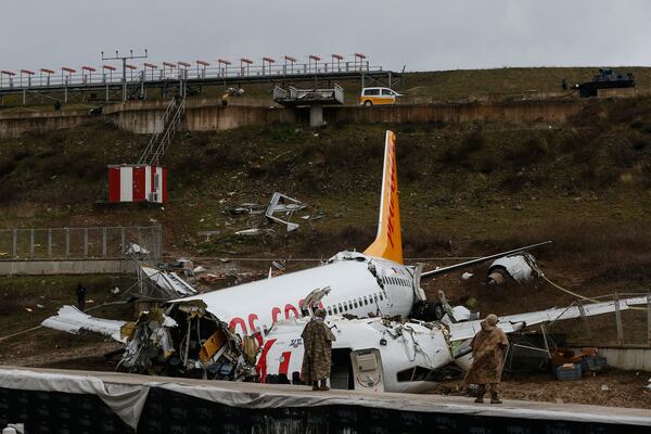 Soldiers guard the wreckage of a plane operated by Pegasus Airlines.