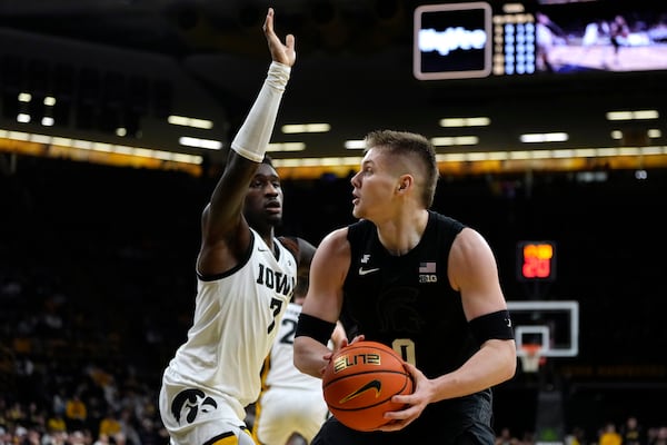 Michigan State forward Jaxon Kohler, right, drives past Iowa forward Seydou Traore (7) during the first half of an NCAA college basketball game, Thursday, March 6, 2025, in Iowa City, Iowa. (AP Photo/Charlie Neibergall)