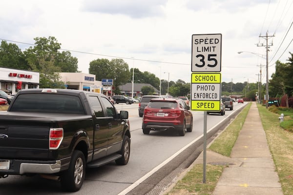 A speed limit sign on U.S. Highway 78 in Snellville by South Gwinnett High School with a "photo enforced" warning. (Tyler Wilkins / tyler.wilkins@ajc.com)