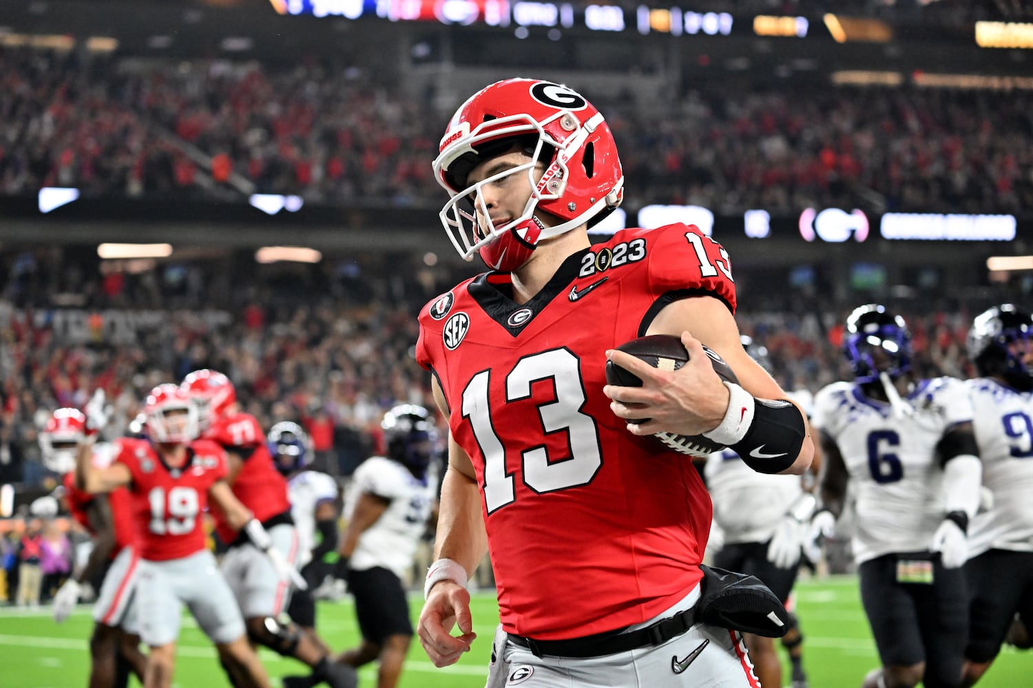 Georgia Bulldogs quarterback Stetson Bennett (13) scores against the TCU Horned Frogs during the first half of the College Football Playoff National Championship at SoFi Stadium in Los Angeles on Monday, January 9, 2023. (Hyosub Shin / Hyosub.Shin@ajc.com)