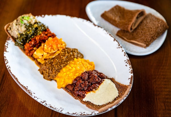 The vegan sampler at Feedel Bistro is served with teff injera (spongy, tangy flatbread) . CONTRIBUTED BY HENRI HOLLIS