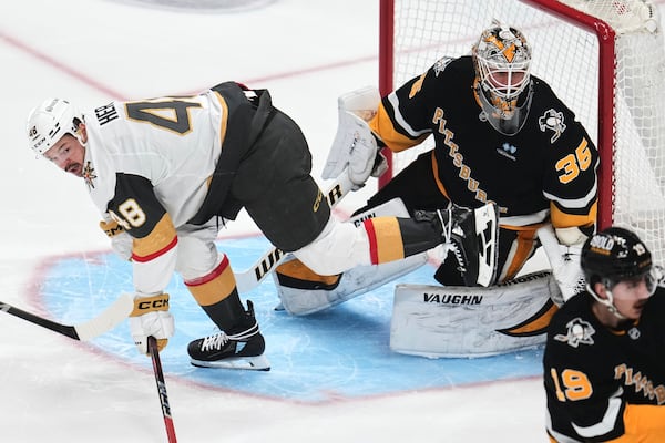 Vegas Golden Knights' Tomas Hertl (48) skates through the goal crease past Pittsburgh Penguins goaltender Tristan Jarry (35) during the first period of an NHL hockey game in Pittsburgh, Tuesday, March 11, 2025. (AP Photo/Gene J. Puskar)