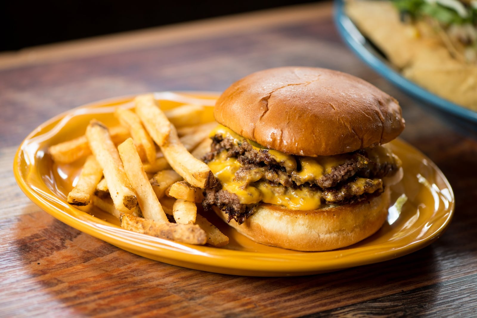  Double Smash Burger with two Black Angus patties, American cheese, mustard, onion, and pickle. Photo credit- Mia Yakel.