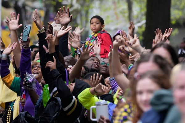 Revelers vie for throws during the Krewe of Zulu parade on Mardi Gras Day, Tuesday, March 4, 2025 in New Orleans. (AP Photo/Gerald Herbert)