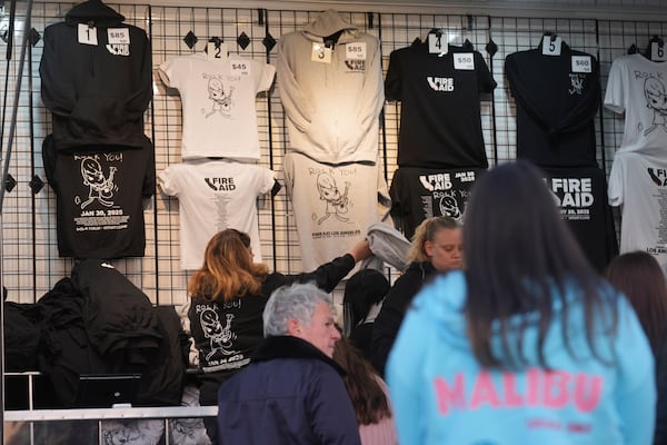 T-shirts promoting the FireAid benefit concert are seen on display on Thursday, Jan. 30, 2025, at The Forum in Inglewood, Calif. (AP Photo/Chris Pizzello)