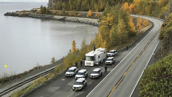 An Oct. 2, 2019, photo shows police at the scene where human remains were found along Seward Highway in Anchorage, Alaska. Brian Steven Smith, 48, of Anchorage, was charged Monday, Oct. 7, 2019, with murder after being connected to the case.