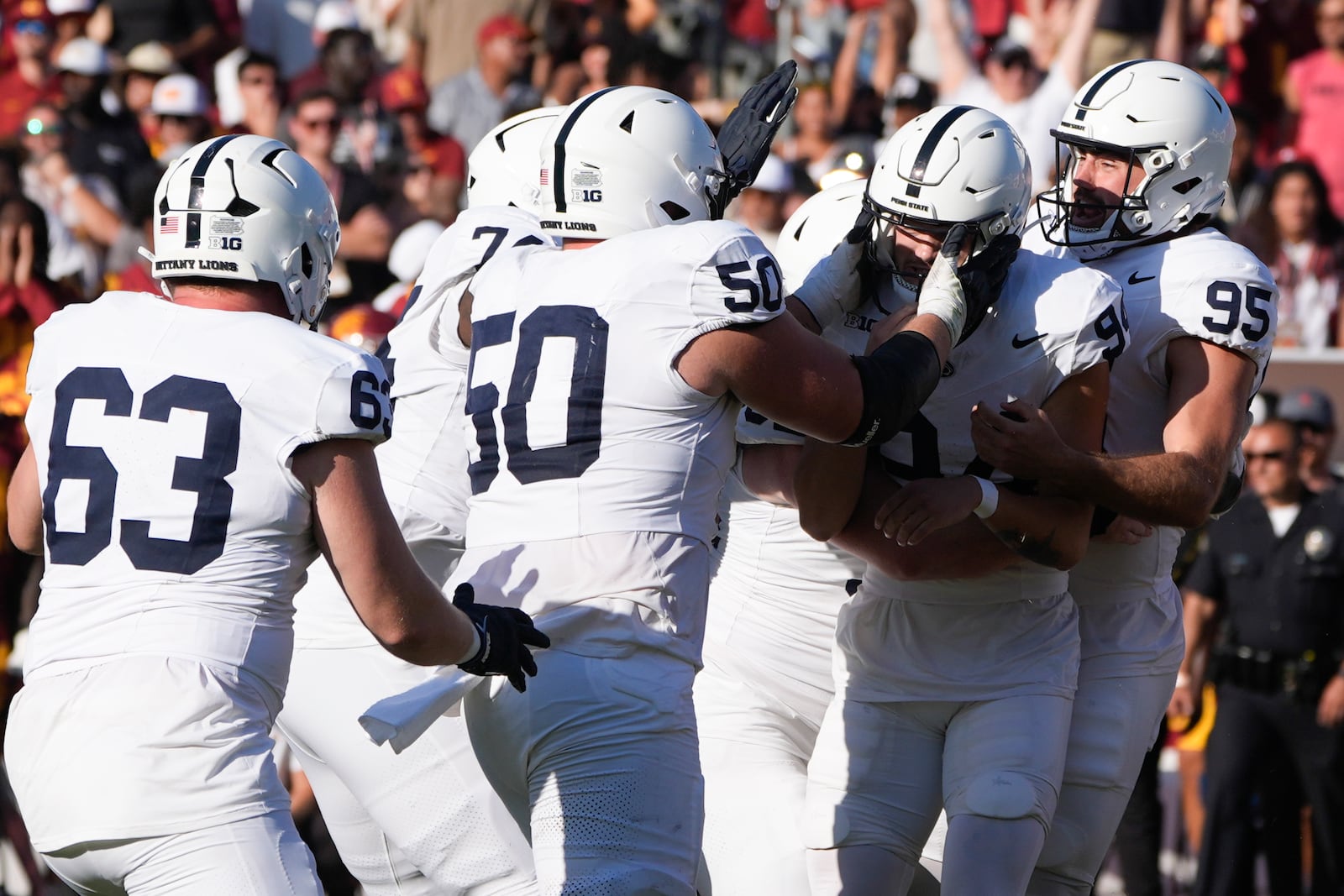 Penn State place kicker Ryan Barker, second from right, is mobbed by teammates after making the game-winning field goal during overtime of an NCAA college football game against Southern California, Saturday, Oct. 12, 2024, in Los Angeles. (AP Photo/Marcio Jose Sanchez)