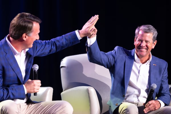 (L-R) Virginia Gov. Glenn Youngkin and Georgia Gov. Brian Kemp high five at The Gathering conservative political conference in Buckhead on Saturday, August 19, 2023. (Arvin Temkar / arvin.temkar@ajc.com)
