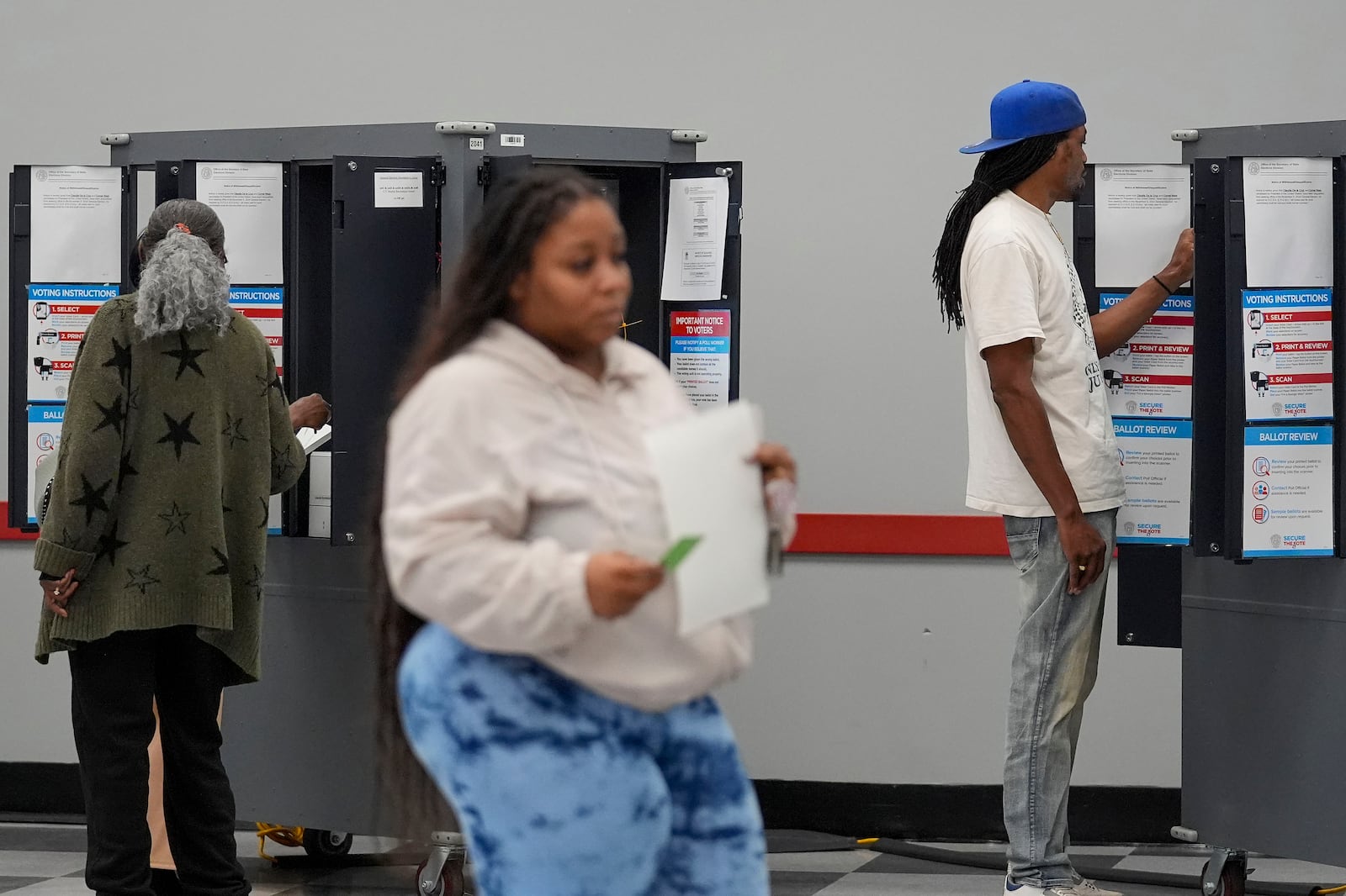 People cast their ballots, Tuesday, Nov. 5, 2024, in Atlanta. (AP Photo/Brynn Anderson)