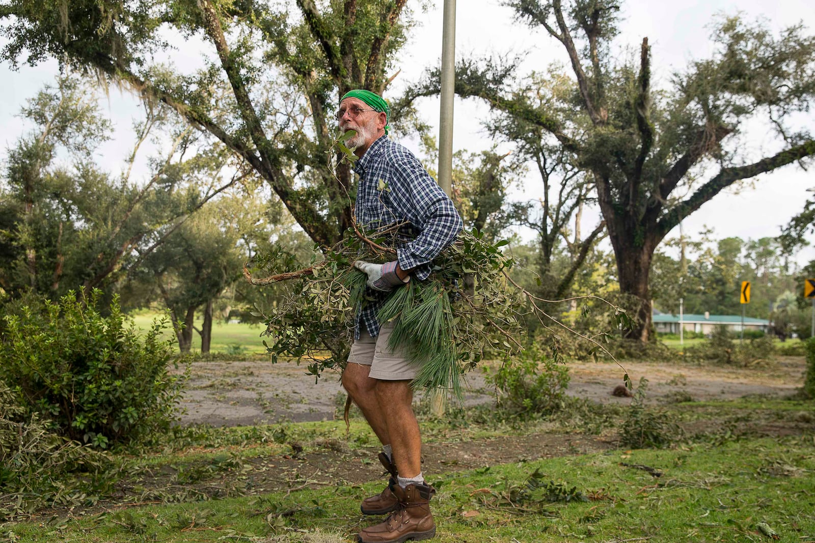 10/11/2018 -- Albany, Georgia -- Ron Smith cleans up broken limbs and debris from his yard a day after Hurricane Michael passed through Albany, Thursday, October 11, 2018.  (ALYSSA POINTER/ALYSSA.POINTER@AJC.COM)