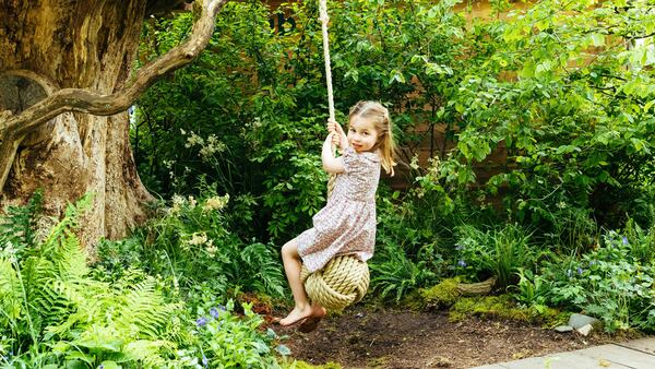 In this image made available on Sunday, May 19, 2019, by Kensington Palace, Britain's Princess Charlotte, daughter of Prince William and Kate, Duchess of Cambridge plays in the Adam White and Andree Davies co-designed garden ahead of the RHS Chelsea Flower Show in London.