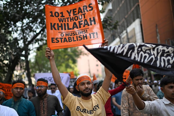 Members and supporters of the banned Islamist group Hizbut Tahrir march near Baitul Mokarram Mosque in Dhaka, Bangladesh, Friday, March 7, 2025. (AP Photo/Mahmud Hossain Opu)