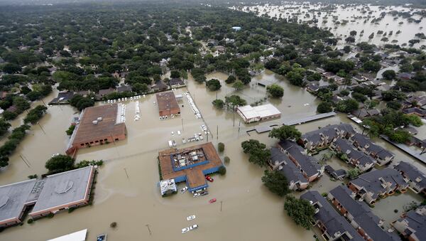 Businesses and neighborhoods near Addicks Reservoir is flooded by floodwaters from Tropical Storm Harvey Tuesday, Aug. 29, 2017, in Houston. (AP Photo/David J. Phillip)