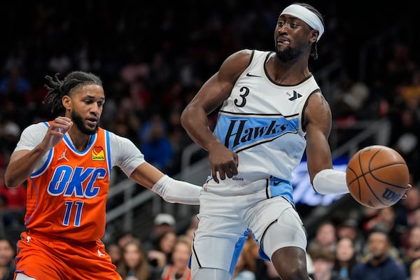 Atlanta Hawks guard Caris LeVert (3) passes the ball against Oklahoma City Thunder guard Isaiah Joe (11) during the first half of an NBA basketball game, Friday, Feb. 28, 2025, in Atlanta. (AP Photo/Mike Stewart)