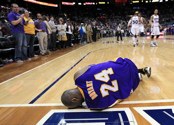 Lakers guard Kobe Bryant lays on the floor in pain after turning his ankle on what would have been a game-tying basket in the closing seconds against the Atlanta Hawks Wednesday, March 13, 2013, in Atlanta. Atlanta won 96-92.