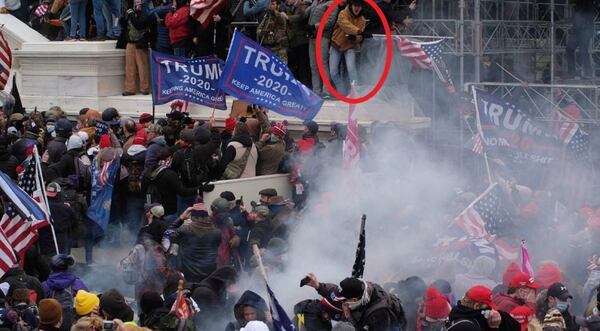 Jake Maxwell, 23 of Athens, (circled) is seen alongside the inaugural stage during the riot at the U.S. Capitol on Jan. 6, 2021.