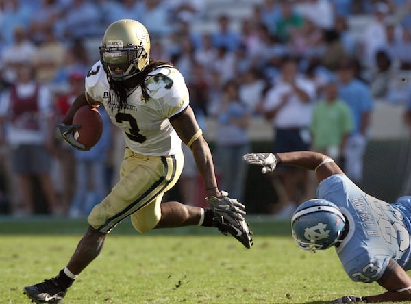 Georgia Tech's Rashaun Grant escapes from North Carolina's Hilee Taylor (33) in the 3rd quarter in Chapel Hill, NC on Saturday, 11/11/06.  Tech won the game 7 to 0.  (AJC file photo by Johnny Crawford)