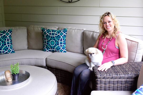 Leslie McCoy, owner of Image Makers Salon Suites in Suwanee, with her dog, Maya, decorated the covered patio with a curved set from Georgia Patio. Her son, Lincoln, was born in July 2017. Text by Lori Johnson and Kelsey E. Green/Fast Copy News Service.(Christopher Oquendo Photography/www.ophotography.com)