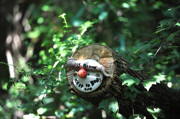 One of "found art" pieces and also first clue to lead to Doll's Head Trail at Constitution Lakes Park near the intersection of South River Industrial Boulevard Road and Moreland Avenue on Friday, July 29, 2014. It's called Doll's Head Trail because of many "found art" pieces created with trash, many of it doll heads, that is left over after the South River floods. HYOSUB SHIN / HSHIN@AJC.COM