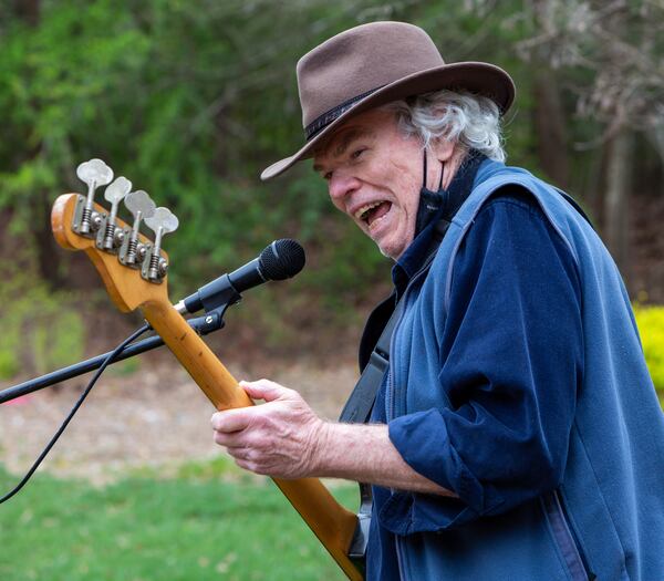 The Druid Hills Billys band member Jim Culliton laughs after telling a story as they perform at Clairmont Place in Decatur. The band, made up of physicians in the area, which regularly played at Clairmont Place before the pandemic, kept it up and increased performances during the lockdown. They played outdoors with residents listening from their balconies. PHIL SKINNER FOR THE ATLANTA JOURNAL-CONSTITUTION.