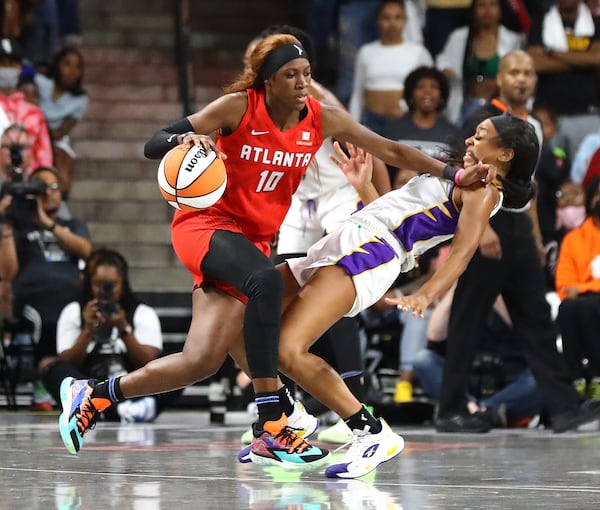 Atlanta Dream guard Rhyne Howard knocks Los Angeles Sparks defender Lexie Brown to the hardwood for an offensive foul during the final minute of a 77-75 victory in the home opener of a WNBA basketball game on Wednesday, May 11, 2022, in College Park.    “Curtis Compton / Curtis.Compton@ajc.com”