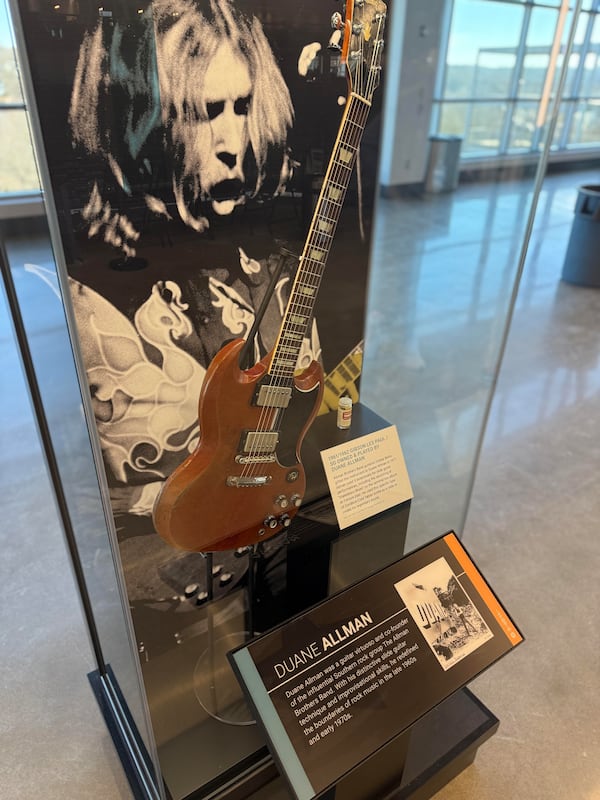 Duane Allman’s Gibson SG, the slide guitar he used to create transformative sounds for the Allman Brothers Band, is on display at Akins Ford Arena in Athens. (Fletcher Page/AJC)