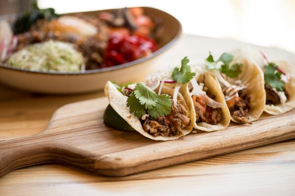  Lil' Street Tacos with cocoa dusted pork carnitas, salsa abodo, crema, radish, queso cotija, yellow onion, cilantro and lime. Photo credit- Mia Yakel.